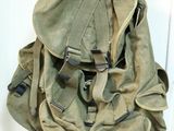 a backpack hanging on the wall by the door
