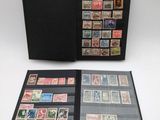 a black folder with stamps on it sitting on top of a table