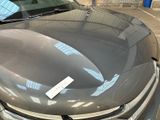 a car with a sticker on the hood of it