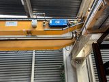 a crane that is hanging from the ceiling of a building