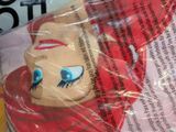 a close up of a bag of food with a doll on it