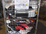 a metal cart with many items in it in a warehouse