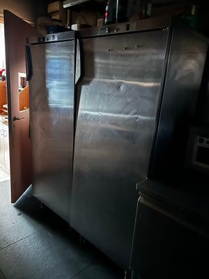 a refrigerator that is in a kitchen with a door open