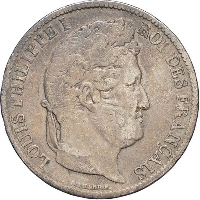 a close up of a coin with a man ' s face on it