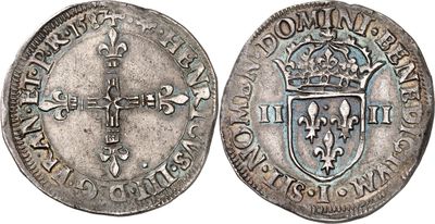 a silver coin with a cross on the front and a shield on the back