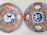 two plates with designs on them on a white surface