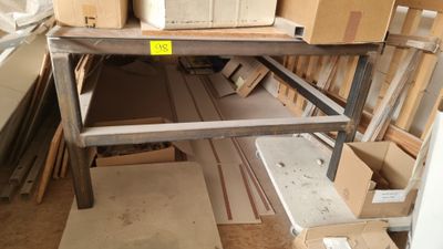 a pile of boxes sitting on a shelf in a room