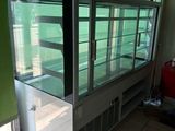 a glass display case in the middle of a room