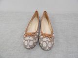 pair of women ' s shoes with bows on them sitting on a bed