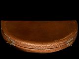 a brown case that is sitting on a black surface