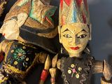 three wooden figurines that are sitting on a table
