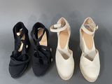 three pairs of black and white shoes with bows on them