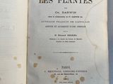 an open book on a table with a black and white image of a plant