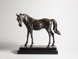 statue of a horse standing on a marble base against a white background