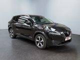 the black nissan qx suv is parked in a large room