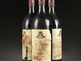 three bottles of wine sitting on top of a table next to each other