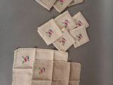 several pieces of cloth with pink flowers on them are laid out on a table