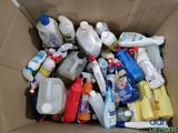 a cardboard box filled with bottles and containers of cleaning products