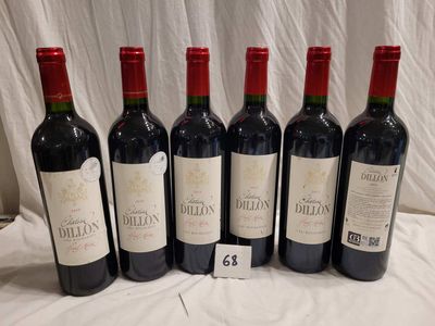 six bottles of red wine are lined up on a table