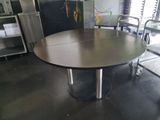 a table that has a bunch of chairs around it