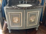 a bathroom vanity with a marble counter top and a mirror