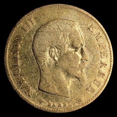a close up of a gold coin with a man ' s face on it