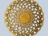 a gold brooch with a yellow center on a blue background