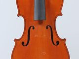 an old violin sitting on top of a wooden stand