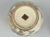 a close up of a vase on a white surface