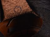 a hand that is holding a piece of leather
