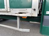 a close up of a green truck with its door open