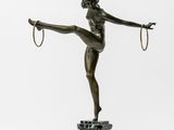 a bronze statue of a woman with a hoop on her head