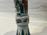 un grand vase décoré d'une peinture, posé sur une table
