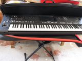 a keyboard sitting on top of a stand in a room