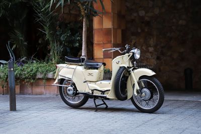 a moped that is parked on the side of the street