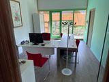 a room with a desk, chair, and a computer on it