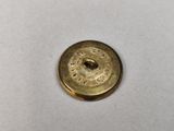 a close up of a metal button on a white surface
