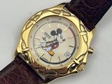 disney mickey mouse watch with brown leather strap on white surface