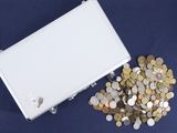 a white box filled with lots of coins on a blue surface