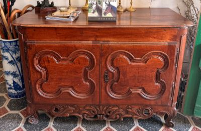 a wooden cabinet with a mirror on top of it