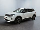 a white suv parked in a room with a black floor