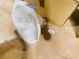 a white umbrella sitting on the floor next to a box