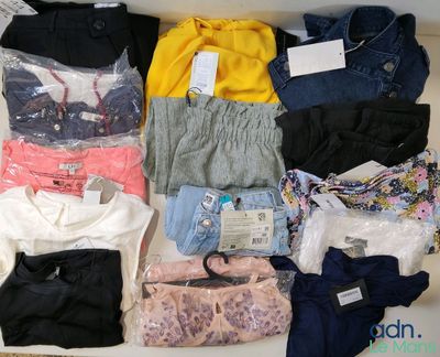 a lot of clothes that are sitting on a table