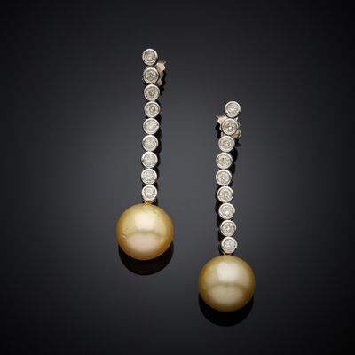 a pair of pearl and diamond earrings