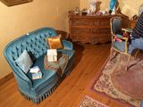 une femme assise sur un canapé bleu dans un salon