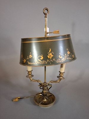 a lamp that is sitting on a table with a lamp shade on it