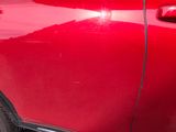 a red car parked on the side of the street