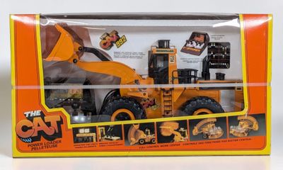 a box with a toy truck in it on a white surface