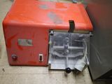 a small orange machine that is sitting on the floor