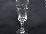 a wine glass sitting on a table with other wine glasses